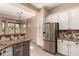 Charming kitchen featuring granite countertops, stainless steel appliances, and mosaic backsplash at 16837 W Northampton Rd, Surprise, AZ 85374