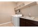 Functional laundry room is equipped with modern appliances, sink, and ample storage space at 16837 W Northampton Rd, Surprise, AZ 85374