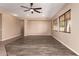 Spacious living room with wood-look floors, neutral walls, and large windows at 16837 W Northampton Rd, Surprise, AZ 85374