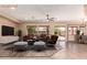 Cozy living room with a large window view, modern furniture, and a seamless transition to the outdoors at 16837 W Northampton Rd, Surprise, AZ 85374