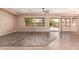 Bright and airy living room offering wood-look flooring, neutral walls, and sliding glass doors to the backyard at 16837 W Northampton Rd, Surprise, AZ 85374
