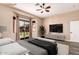 Main bedroom featuring a bay window, ceiling fan, and contemporary furnishings at 16837 W Northampton Rd, Surprise, AZ 85374