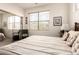 Well-lit bedroom boasts a mirrored closet, neutral tones, and comfortable furnishings at 18077 W Sammy Way, Surprise, AZ 85374