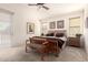 Comfortable bedroom featuring a large bed, side tables with lamps, and bench seating at 18077 W Sammy Way, Surprise, AZ 85374