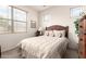 Bright bedroom featuring a large window, plush bedding, and stylish furnishings at 18077 W Sammy Way, Surprise, AZ 85374