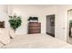Cozy bedroom featuring a dresser with a mounted television and an open doorway at 18077 W Sammy Way, Surprise, AZ 85374