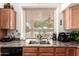 Kitchen area featuring stainless steel sink, modern appliances, and ample cabinet space at 18077 W Sammy Way, Surprise, AZ 85374