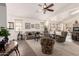 Inviting living room with vaulted ceilings, ceiling fan, and archway openings to the kitchen and hallway at 18077 W Sammy Way, Surprise, AZ 85374