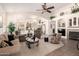 Spacious open-concept living room featuring vaulted ceilings, a fireplace, and seamless flow into the kitchen at 18077 W Sammy Way, Surprise, AZ 85374