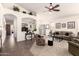 Expansive living room with neutral colors, vaulted ceiling, and a seamless flow to other rooms at 18077 W Sammy Way, Surprise, AZ 85374
