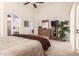 Spacious bedroom with high ceilings, ensuite bath access, and warm, neutral decor at 18077 W Sammy Way, Surprise, AZ 85374