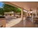 Covered patio perfect for outdoor dining and entertaining, offering a relaxing space with views of a landscaped backyard at 18077 W Sammy Way, Surprise, AZ 85374