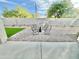Open backyard featuring a paver patio, outdoor furniture, artificial turf, and privacy wall at 18100 N Piccolo Dr, Maricopa, AZ 85138