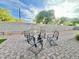 Wide shot of the backyard featuring a paver patio, artificial turf and block wall at 18100 N Piccolo Dr, Maricopa, AZ 85138