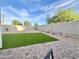 Landscaped backyard with artificial turf, stone, and block wall for privacy at 18100 N Piccolo Dr, Maricopa, AZ 85138