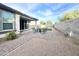 View of a covered patio, outdoor seating, artificial turf, landscaped yard and block wall at 18100 N Piccolo Dr, Maricopa, AZ 85138