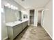 Spacious bathroom with double sinks, a large mirror, and tile flooring at 18100 N Piccolo Dr, Maricopa, AZ 85138