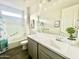 Clean bathroom featuring a sink, tub, shower, and gray cabinets with a faux plant at 18100 N Piccolo Dr, Maricopa, AZ 85138