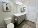 Bright bathroom showcasing a double sink, gray cabinets, and white finishes at 18100 N Piccolo Dr, Maricopa, AZ 85138