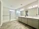 Modern bathroom features a double sink vanity and a glass-enclosed shower at 18100 N Piccolo Dr, Maricopa, AZ 85138