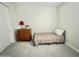 Simple bedroom with a twin bed, wooden dresser, and carpet flooring at 18100 N Piccolo Dr, Maricopa, AZ 85138