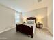 This bedroom features a full size bed, side tables, and neutral-toned walls and carpet at 18100 N Piccolo Dr, Maricopa, AZ 85138