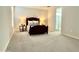 Spacious bedroom featuring neutral walls and soft carpeting, with an adjacent bathroom visible at 18100 N Piccolo Dr, Maricopa, AZ 85138