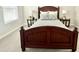 Classic bedroom with a wooden-frame bed, side tables, and lamps, creating a comfortable and welcoming space at 18100 N Piccolo Dr, Maricopa, AZ 85138