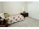 Cozy bedroom featuring a floral bedspread, dresser, and neutral carpet at 18100 N Piccolo Dr, Maricopa, AZ 85138
