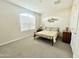 Bedroom showcasing a metal frame bed, neutral carpet, and large window at 18100 N Piccolo Dr, Maricopa, AZ 85138
