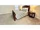 Bedroom features a full-size bed with patterned bedding, side tables and soft carpeting at 18100 N Piccolo Dr, Maricopa, AZ 85138