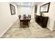 Dining room with dark wood furniture, gray walls, and wood-look tile flooring at 18100 N Piccolo Dr, Maricopa, AZ 85138