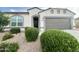 Charming single-story home with neutral stucco, gray accents, and a well-maintained landscaped front yard at 18100 N Piccolo Dr, Maricopa, AZ 85138