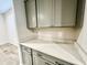 Close-up of kitchen details highlighting the gray cabinets, hardware, and quartz countertops along the back wall at 18100 N Piccolo Dr, Maricopa, AZ 85138