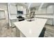 Modern kitchen with quartz countertops, an island, stainless steel appliances, and gray cabinets at 18100 N Piccolo Dr, Maricopa, AZ 85138
