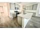 Open kitchen showcasing gray cabinets, stainless steel appliances, and a quartz island with stylish flooring at 18100 N Piccolo Dr, Maricopa, AZ 85138