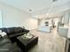 Open-concept living area with kitchen view, sleek sectional sofa, and light, airy feel at 18100 N Piccolo Dr, Maricopa, AZ 85138