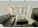 Comfortable living room with wood-look tile flooring and an open-concept design leading to the kitchen at 18100 N Piccolo Dr, Maricopa, AZ 85138