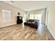 Spacious living room with modern flooring, stylish sectional sofa, and bright natural light at 18100 N Piccolo Dr, Maricopa, AZ 85138