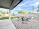 View of the covered patio with paver flooring, backyard with artificial grass, and block wall at 18100 N Piccolo Dr, Maricopa, AZ 85138