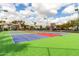 Well-maintained tennis court with vibrant colors and clear skies in a residential setting at 1825 W Ray Rd # 2132, Chandler, AZ 85224