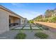 This backyard includes a large covered patio, grass, and gorgeous views at 19045 N 269Th Dr, Buckeye, AZ 85396