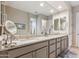 Well-lit bathroom with double vanity, framed mirrors, and modern fixtures at 19045 N 269Th Dr, Buckeye, AZ 85396