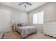 A well lit bedroom with a ceiling fan and a dresser at 19045 N 269Th Dr, Buckeye, AZ 85396
