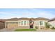 Charming home features desert landscaping, a two-car garage, and a tiled roof at 19045 N 269Th Dr, Buckeye, AZ 85396