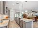 Modern kitchen boasts stainless steel appliances, granite countertops, a large island, and a sleek design at 19045 N 269Th Dr, Buckeye, AZ 85396