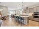 Modern kitchen with a large island, pendant lighting, stainless steel appliances, and bar stool seating at 19045 N 269Th Dr, Buckeye, AZ 85396