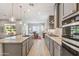 Bright kitchen features granite counters, stainless steel appliances, and an island with bar seating, perfect for dining at 19045 N 269Th Dr, Buckeye, AZ 85396