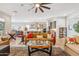 Bright living room with an open concept, showcasing a ceiling fan, recessed lights, and stylish furniture at 19045 N 269Th Dr, Buckeye, AZ 85396