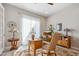Office space featuring a vintage wood desk, wood furniture and light filled windows at 19045 N 269Th Dr, Buckeye, AZ 85396